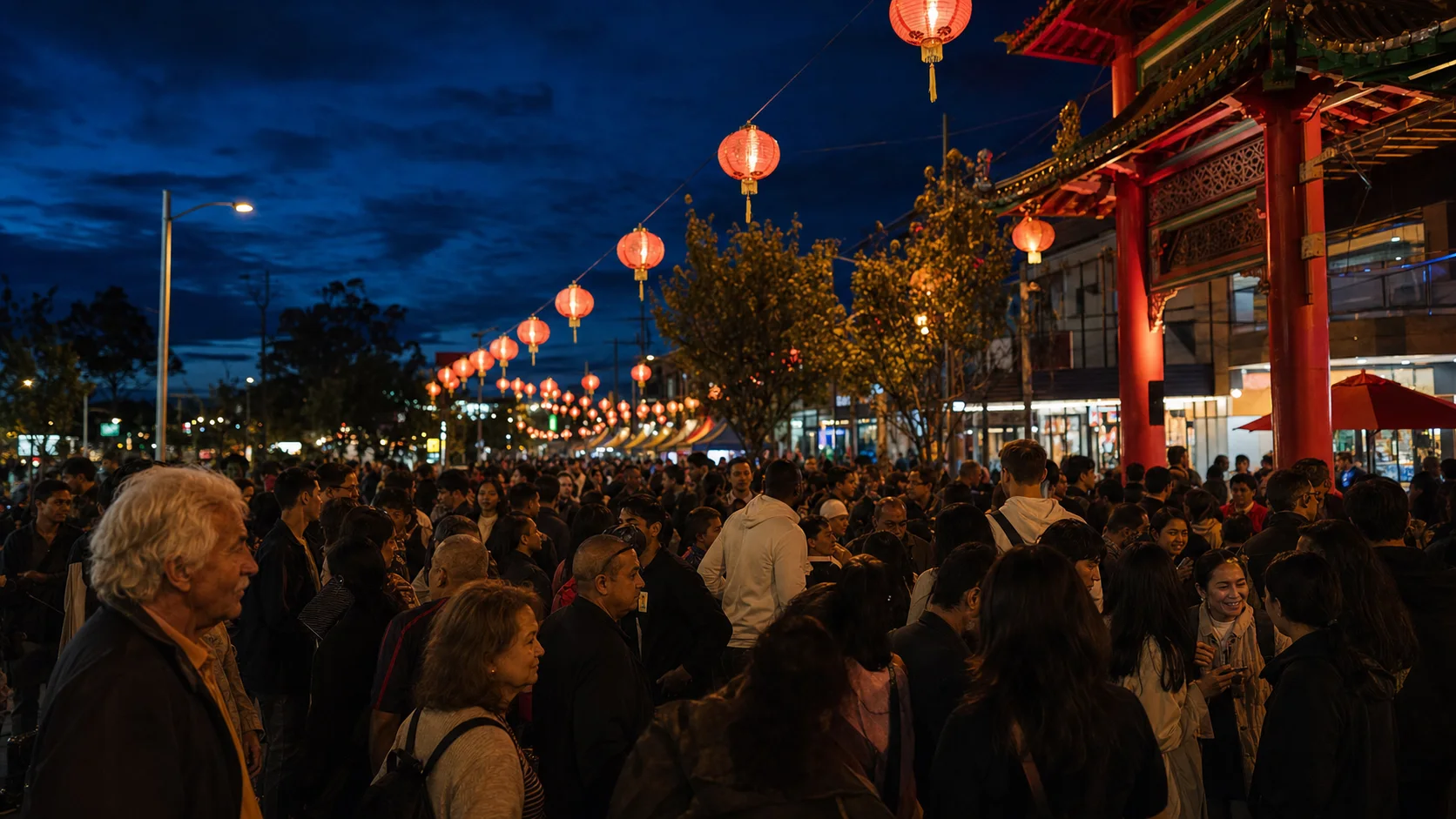 John Street filled with people beneath glowing lanterns after dark